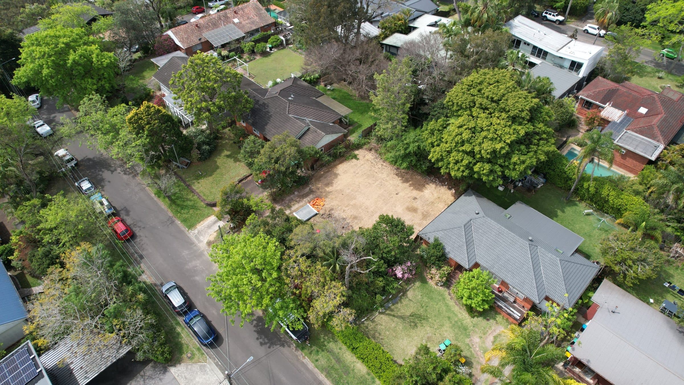 Aerial view of the BlueOrion site, a cleared block between established neighbouring homes
